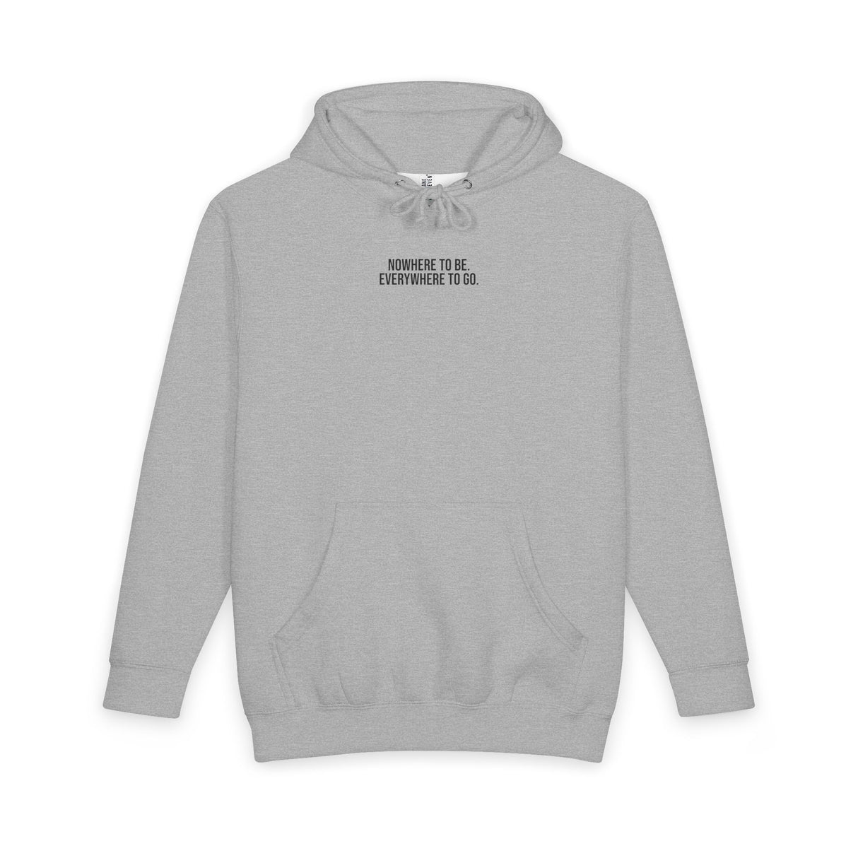 Printify Road Trip Hoodie from the Nature Series featuring the quote "Nowhere to Be. Everywhere to Go." worn by a person outdoors.