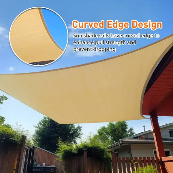 Beige sun shade sail with a curved edge design, providing enhanced pull strength and preventing sagging. Installed on a backyard patio, the durable fabric offers stylish and functional outdoor sun protection under clear blue skies. | PicSEO 1775515536858