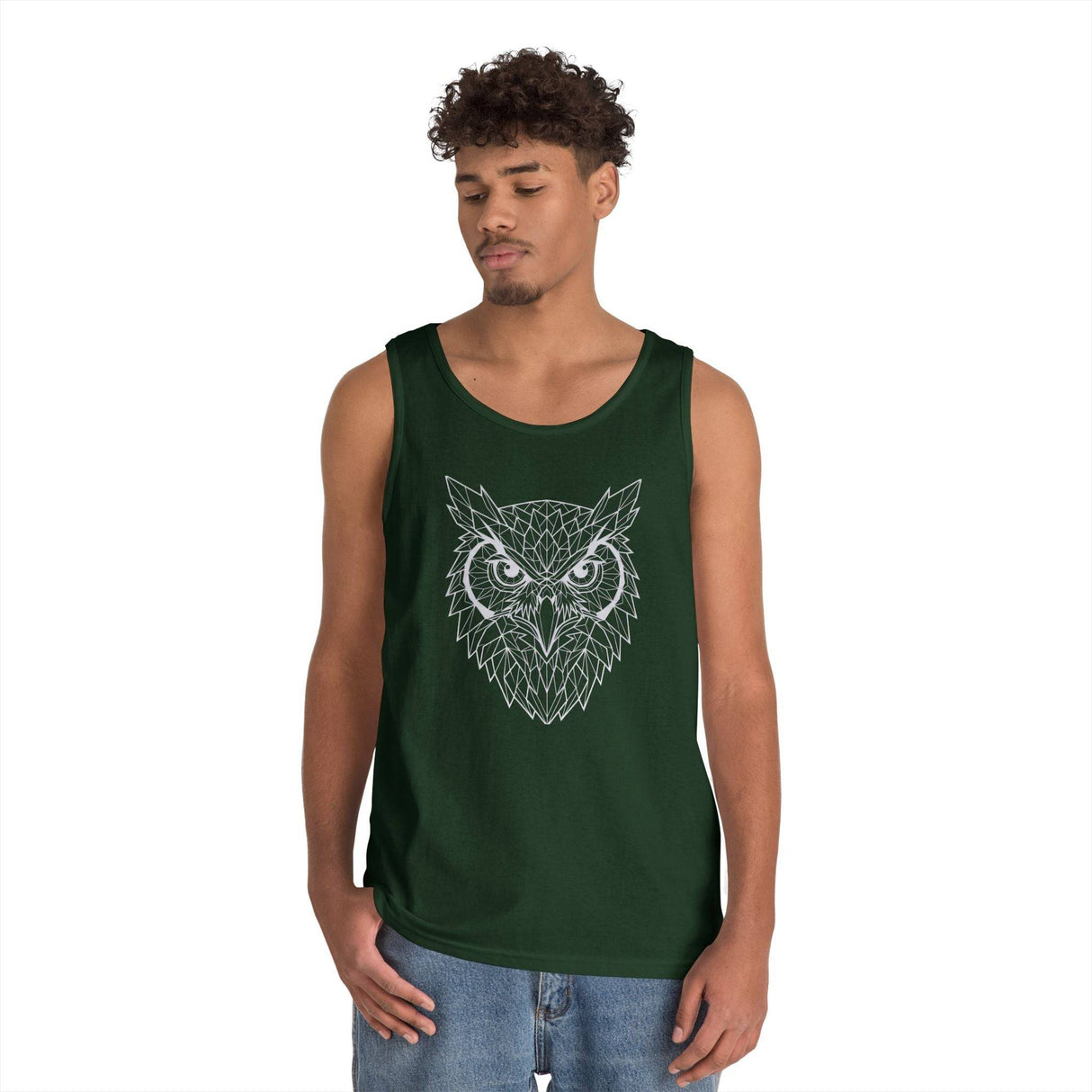 Young man wearing a dark green tank top featuring a geometric owl design in white lines, paired with casual blue jeans, against a plain white background. | PicSEO 1776476553995