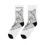 White socks with black geometric wolf design on a white background