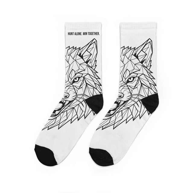 White socks with black geometric wolf design on a white background