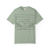 Printify Mountain Tee t-shirt featuring nature-inspired design with the phrase "Built by Nature. Shaped by Choice." on a natural-themed background.