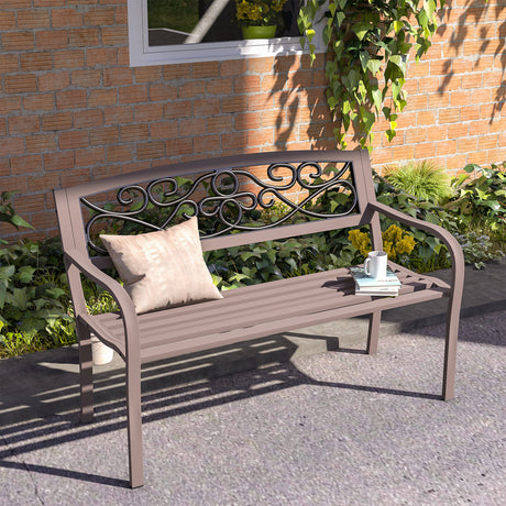 Decorative metal bench with a pillow and small table on a patio