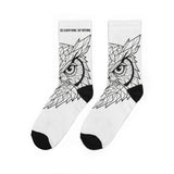 White socks with black owl design and text 'See Everything Say Nothing' on a white background